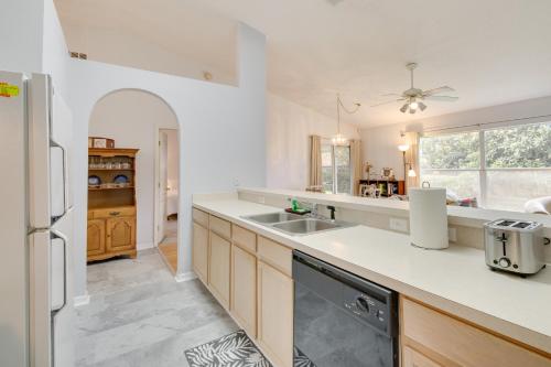 a kitchen with a sink and a refrigerator at 20 Mi to Disney Condo with Pool Access in Clermont! in Clermont