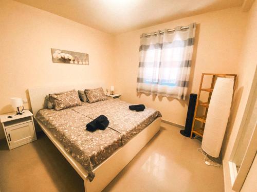 a bedroom with a bed with a black bag on it at Playa Maria Apartment 43 (Puerta al Cielo) in La Playa Calera