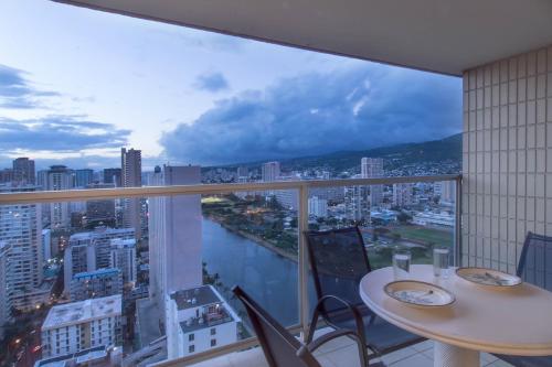 a room with two tables and a large window at Island Colony 3512 in Honolulu