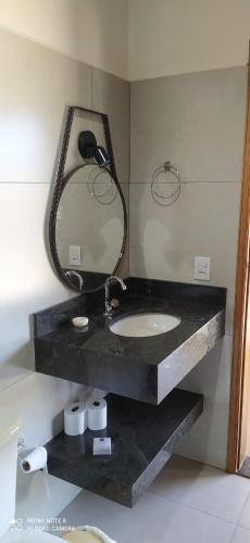 a bathroom with a sink and a mirror at Pousada Sítio Santa Justa in Monte Sião