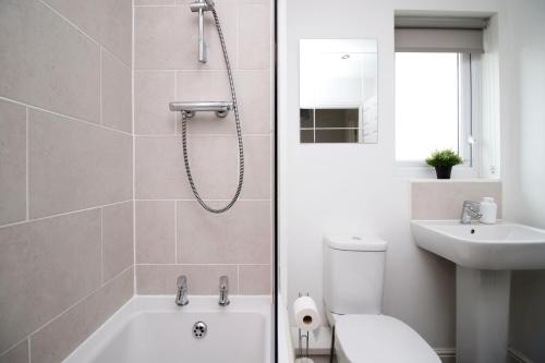 La salle de bains est pourvue d'une douche, de toilettes et d'un lavabo. dans l'établissement Beautiful Modern House with Free Parking, à Swansea