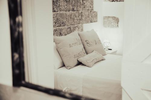 two pillows sitting on a couch in a mirror at Nonna Veronica in Gemini