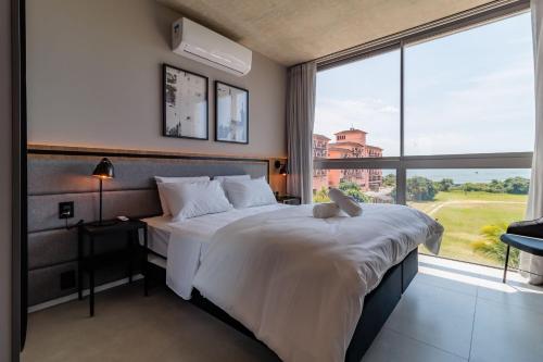 Cama o camas de una habitación en Spot Jurere sofisticación junto al mar - SPJ's