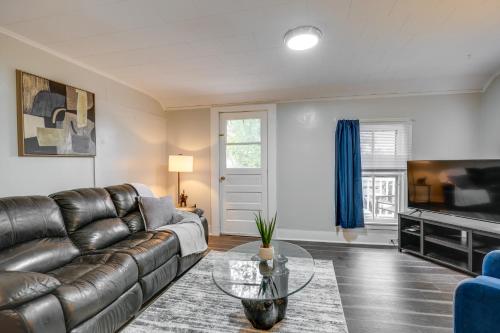a living room with a leather couch and a tv at Pet-Friendly Auburn Apartment with Balcony! in Auburn