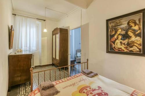 a bedroom with a painting on the wall at Can Mateuet - House Rental by Season in Llagostera