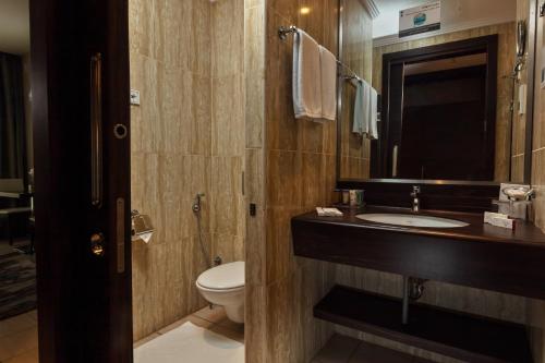 a bathroom with a sink and a toilet at M Hotel Makkah by Millennium in Mecca