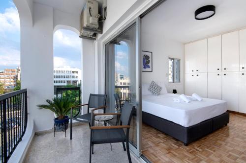 a bedroom with a bed and a balcony at Urban Condo 10 - 2 Bdr in Nicosia
