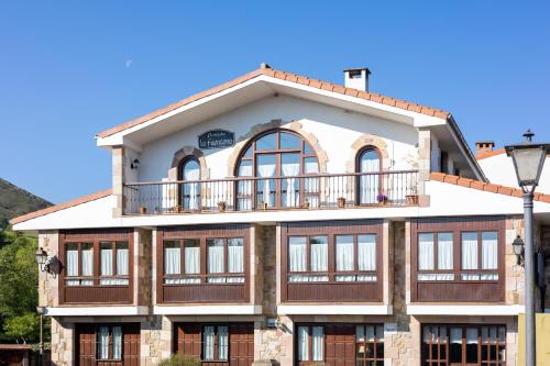 a large building with windows and a balcony at La Fuentona de Ruente in Ruente