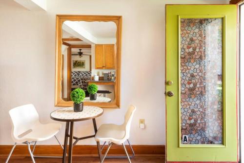 a dining room with a table and chairs and a mirror at Belong Downtown 1br 1ba in Gainesville