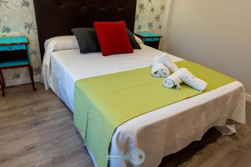 a bedroom with a large bed with towels on it at EDIFICIO 1521 in Logroño