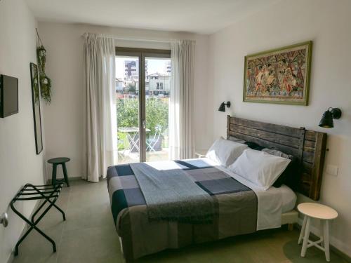 a bedroom with a large bed and a window at B&B Ramerino in Grosseto