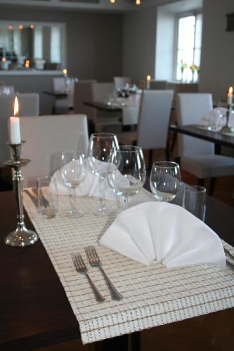 a table with wine glasses and a plate on it at Mauritzbergs Slott & Golf in Mauritsberg