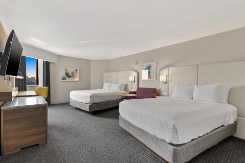 a hotel room with two beds and a flat screen tv at Crowne Plaza Houston Med Ctr-Galleria Area, an IHG Hotel in Houston