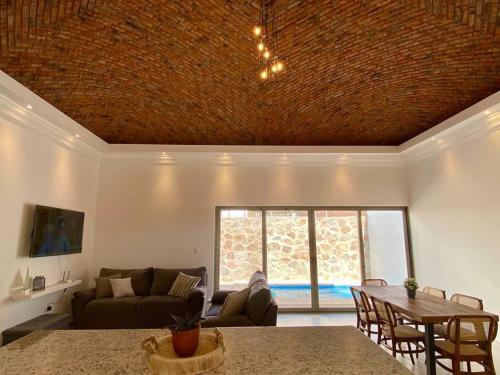 a living room with a couch and a table at CASA PITAHAYA con alberca privada Col El Mirador in San Carlos