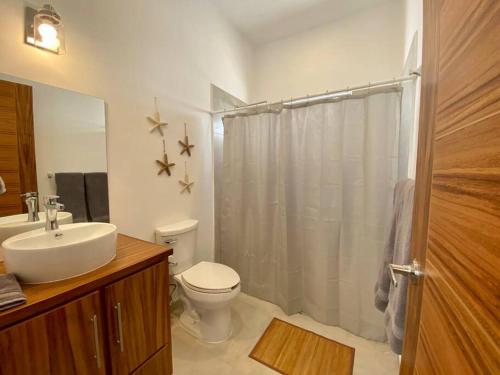 a bathroom with a toilet and a sink and a shower at CASA PITAHAYA con alberca privada Col El Mirador in San Carlos