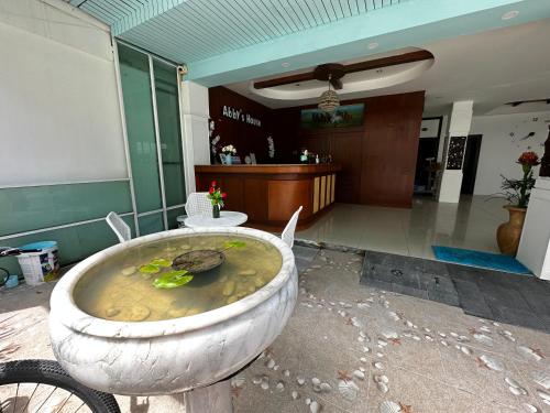 a bath tub with a turtle in the middle of a lobby at Abby's House Hotel in Patong Beach