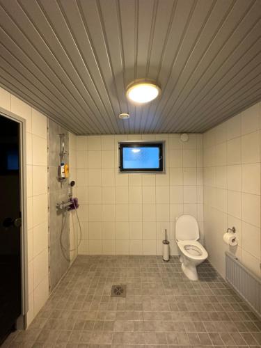 baño con aseo y ventana en Your home away from home! en Rovaniemi