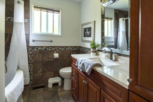 a bathroom with a sink and a toilet and a mirror at Grays Lane - Minutes to Sandbanks in Bloomfield