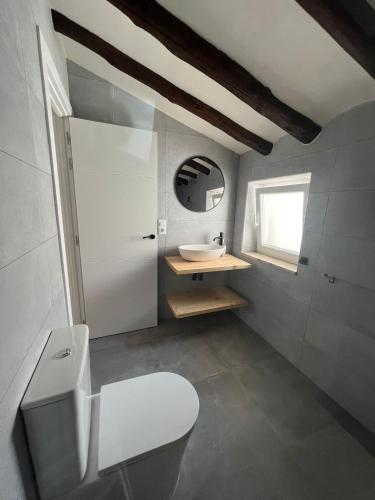 a bathroom with a white toilet and a sink at Casa Azul in Vélez Blanco