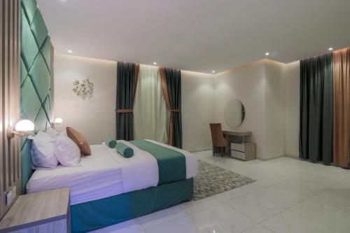 a bedroom with a bed and a table in a room at جراند فيوتشر in Abha