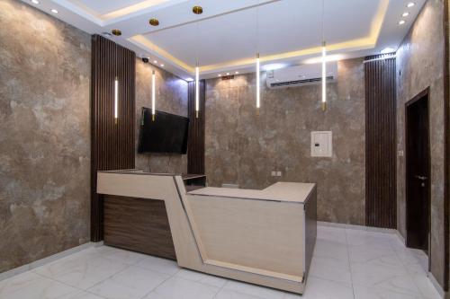a lobby with a reception desk and a television at جراند فيوتشر in Abha