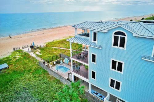 an aerial view of a blue house and the beach at Bird's Eye View in St. George Island