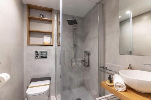 a bathroom with a shower and a toilet and a sink at Arrantzale Etxea in Getxo