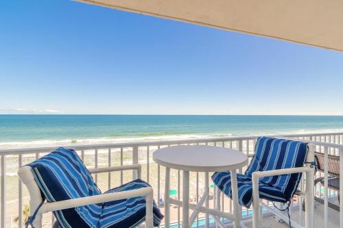 a balcony with two chairs and a table and the ocean at Direct Oceanfront Condo, Daytona Beach, sleeps 4 - with pool in Daytona Beach