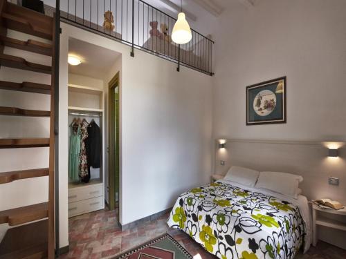 a small bedroom with a bed and a staircase at B&B ai Condotti di Pisa da Filippo in San Giuliano Terme
