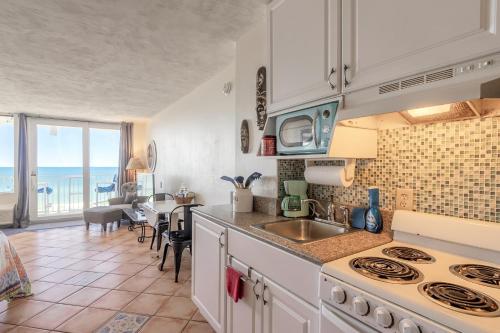 a kitchen with a sink and a counter top at Direct Oceanfront Condo, Daytona Beach, sleeps 4 - with pool in Daytona Beach