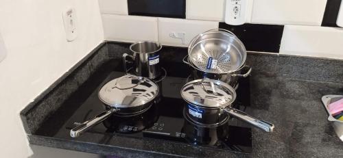 a kitchen counter with two pots and pans on a stove at Lapa Bed and breakfast Apartamento Rio de Janeiro in Rio de Janeiro