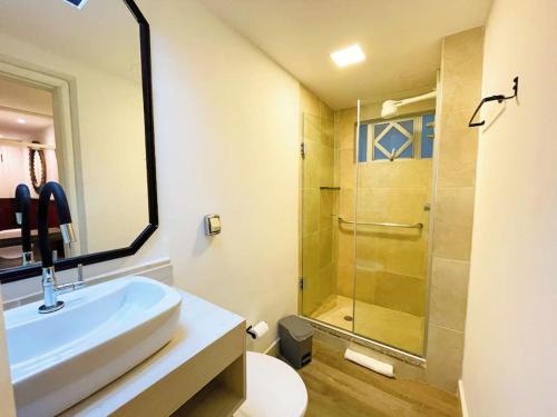 a bathroom with a sink and a shower at Studio Duque Classic in Porto Alegre