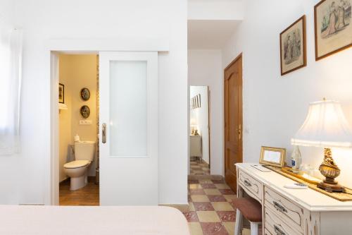 Casa Doña Carmela GuestHouse - Adults Only في سانتا كروث دي تينيريفه: صورتين لحمام مع حوض ومرحاض