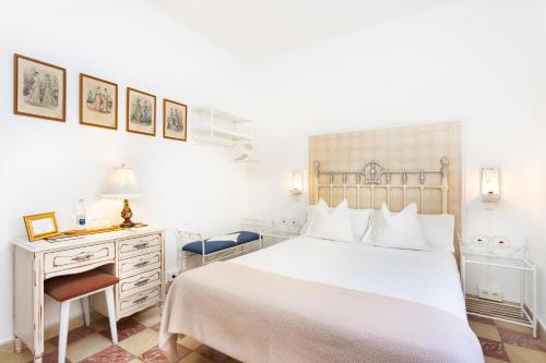 a white bedroom with a white bed and a desk at Casa Doña Carmela GuestHouse - Adults Only in Santa Cruz de Tenerife
