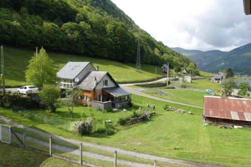 a house in a field with a herd of animals at Ha-Py Friends in Campan