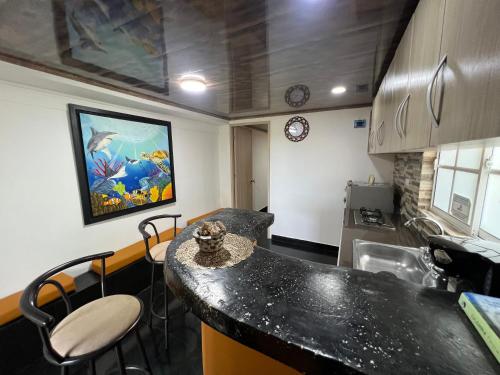 a kitchen with a black counter top in a room at Posada Ashanty in Providencia
