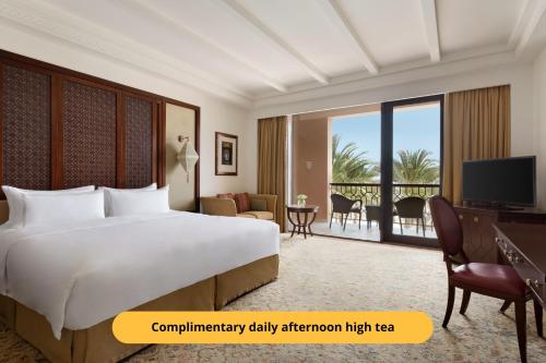 a hotel room with a bed and a balcony at Shangri-La Al Husn, Muscat - Adults Only Resort in Muscat