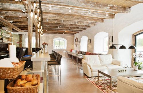 a lobby with white furniture and tables and windows at Mauritzbergs Slott & Golf in Mauritsberg