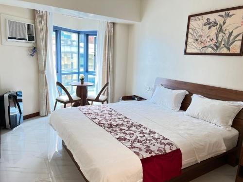 a bedroom with a large bed in a room at Beachfront U.S. Embassy Family Retreat. in Manila