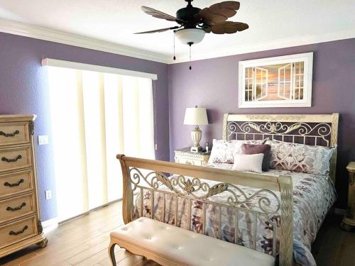 a bedroom with a bed and a ceiling fan at Oasis Away Englewood, Florida! Spacious home w/ heated pool in Englewood