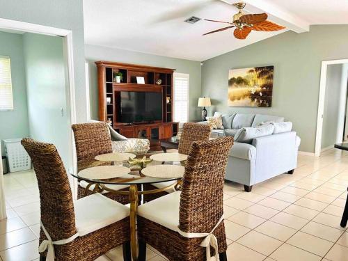 a living room with a couch and a table and chairs at Oasis Away Englewood, Florida! Spacious home w/ heated pool in Englewood