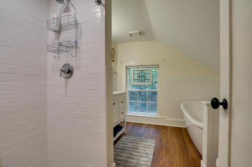 a white bathroom with a shower and a tub at Historic Home in Taylors Falls with Patio and Fire Pit in Taylors Falls