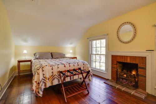 a bedroom with a bed and a fireplace at Historic Home in Taylors Falls with Patio and Fire Pit in Taylors Falls