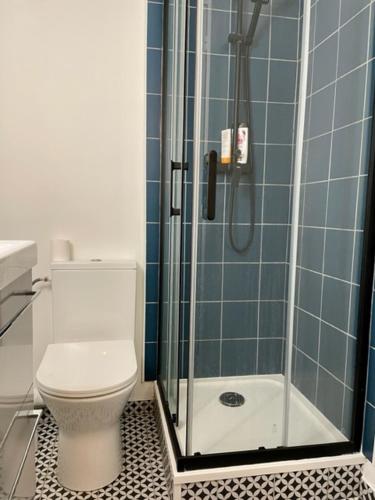 une salle de bain avec toilettes et douche en verre dans l'établissement Beau studio spacieux, à Paris