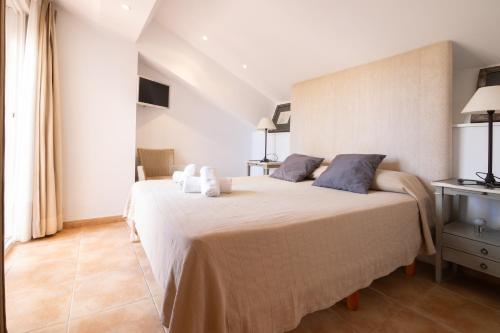 a bedroom with a large bed in a room at Jávea terraza + piscina + vistas al mar in Platja de l'Arenal