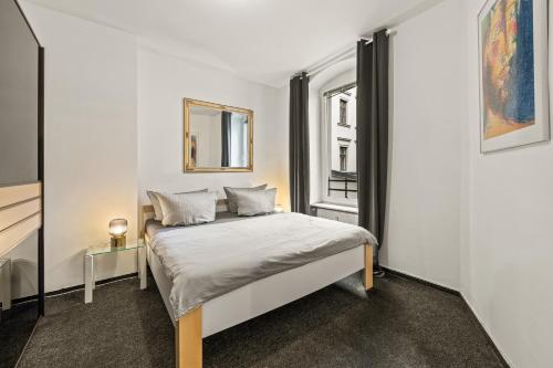 a bedroom with a bed and a window at Apartments am Fernsehturm in Berlin