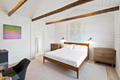 a bedroom with a bed and a desk and a chair at Boutique Room steps from Downtown Mall Rose Jean Room 3 in Charlottesville