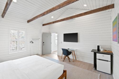 a bedroom with a bed and a desk and a tv at Boutique Room steps from Downtown Mall Rose Jean Room 3 in Charlottesville