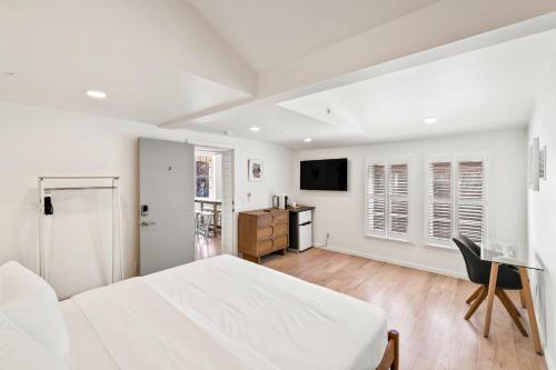 a white bedroom with a bed and a desk at Boutique Room steps from Downtown Mall Rose Jean Room 2 in Charlottesville