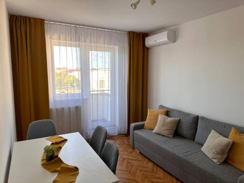 a living room with a couch and a table at Lux Apartment Vivo Mall in Baia Mare